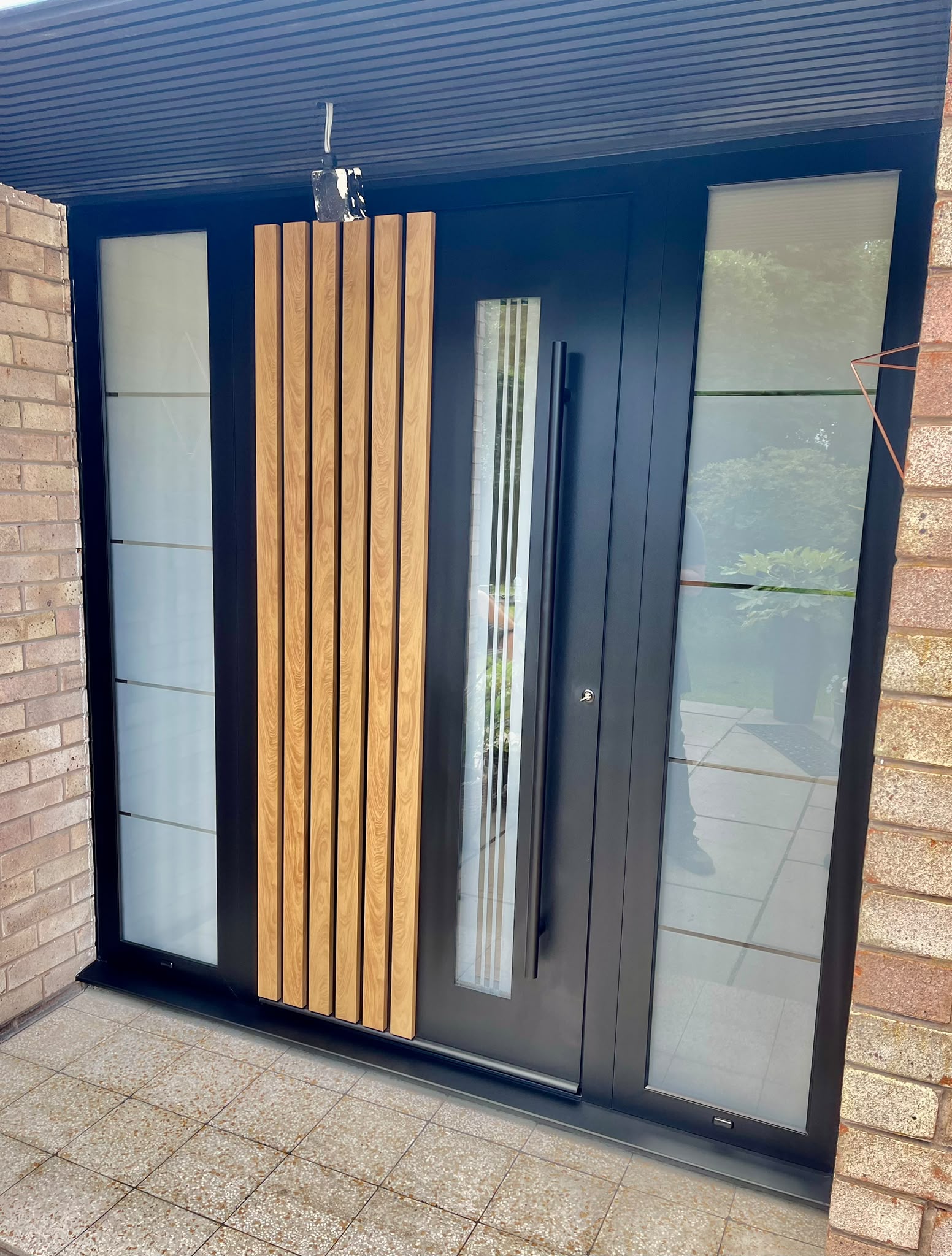 Timber-look vertical detailing set against a dark frame.